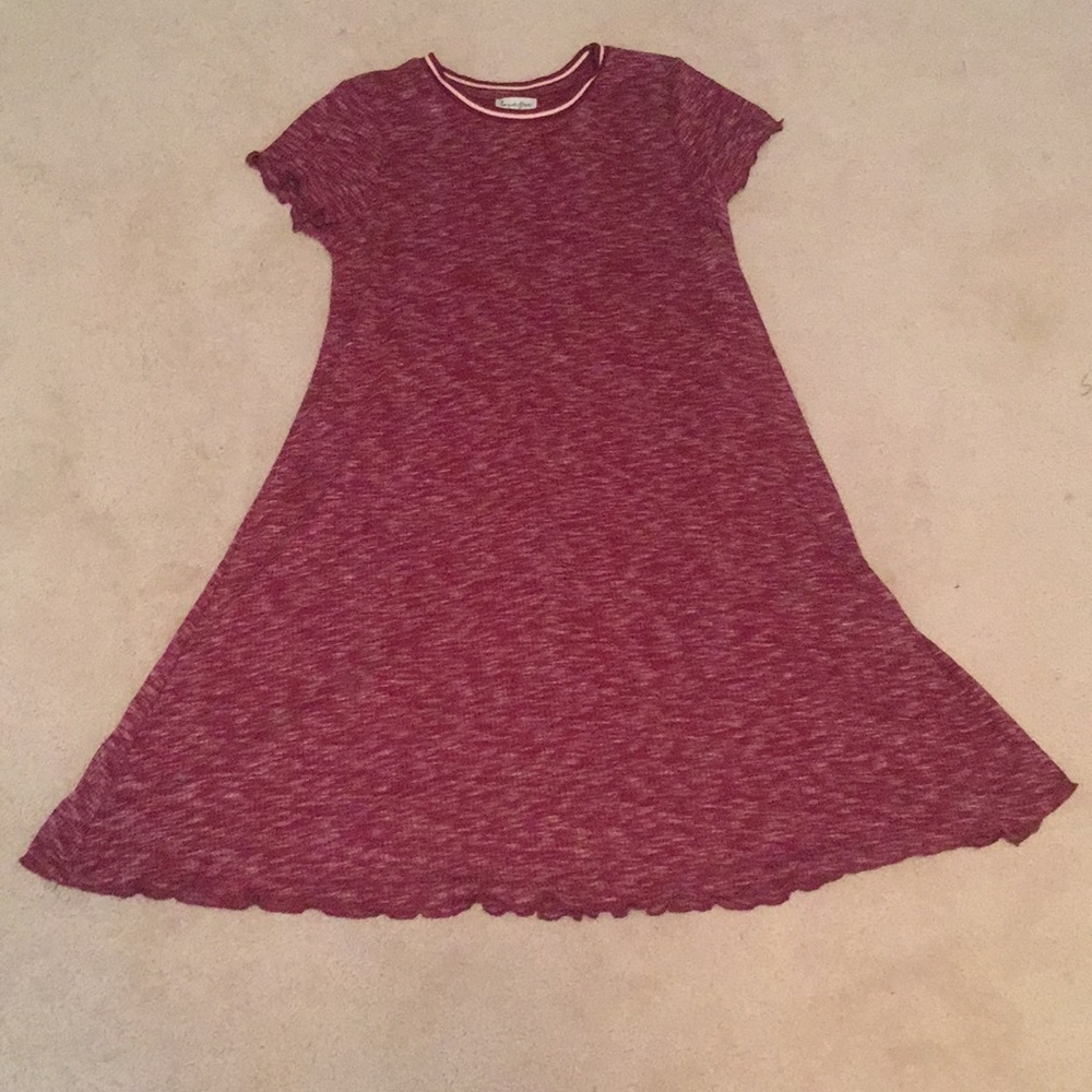 A women’s purple redish color dress.